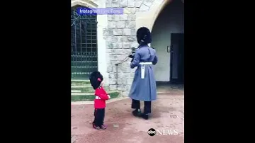 Boy Dressed as British Guard Salutes Windsor Castle Soldiers